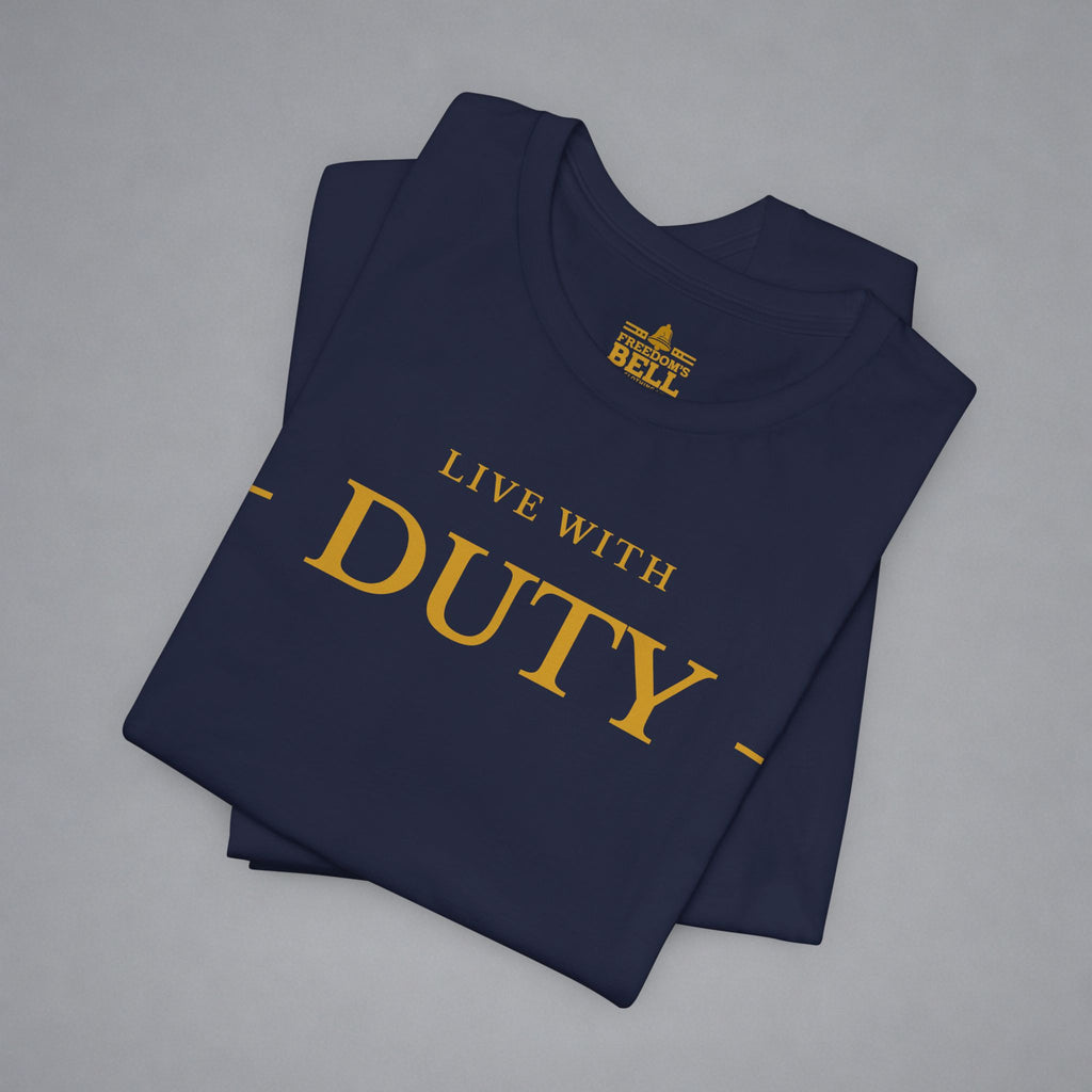A folded navy blue t-shirt with gold text reading 'LIVE WITH DUTY' and a small 'BELL' logo printed inside the collar, displayed on a neutral gray background.