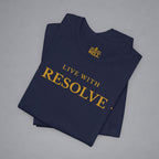 A folded navy blue t-shirt with gold text reading 'LIVE WITH RESOLVE' and a small 'BELLELL' logo printed inside the collar, displayed on a neutral gray background.