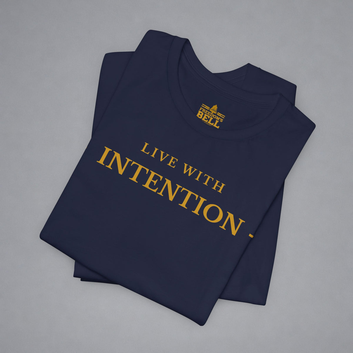 A folded navy blue t-shirt with gold text reading 'LIVE WITH INTENTION.