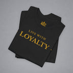 A folded black t-shirt with gold text reading 'LIVE WITH LOYALTY' and a gold 'BELLY' logo printed inside the collar, displayed on a neutral gray background.