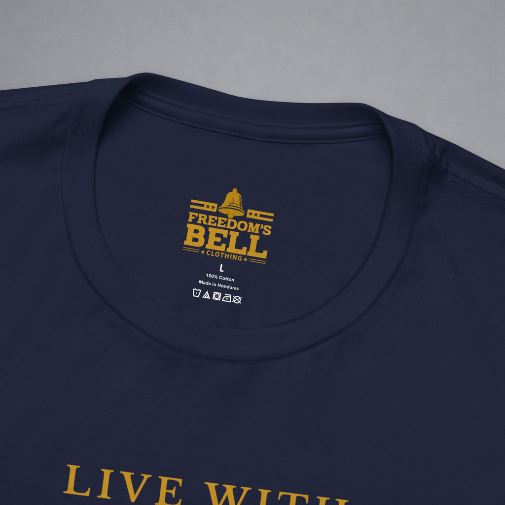 Close-up of a navy blue t-shirt showing the inner neck label with gold text that reads 'FREEDOM'S BELL A CLOTHING' and part of the gold 'LIVE WITH' text printed on the front, set against a neutral gray background.