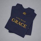 A folded navy blue t-shirt with gold text reading 'LIVE WITH GRACE' and a small 'BELLELL' brand logo printed inside the collar, displayed on a neutral gray background.