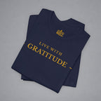 Folded navy blue t-shirt with 'Live with Courage' text on a gray background