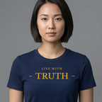 A woman with a short dark bob hairstyle wearing a navy blue crewneck t-shirt with the text 'LIVE WITH - TRUTH -' printed in gold on the chest, set against a solid gray background.