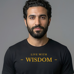 A man with a beard and dark hair wearing a black t-shirt with the text 'LIVE WITH - WISDOM -' printed in gold on the chest, set against a solid gray background.