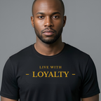 A man wearing a black crew-neck t-shirt with the text 'LIVE WITH - LOYALTY -' printed in gold across the chest, set against a solid gray background.