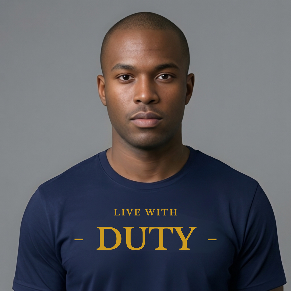 A man wearing a navy blue crewneck t-shirt with 'LIVE WITH - DUTY -' printed in gold lettering across the chest, set against a solid gray background.