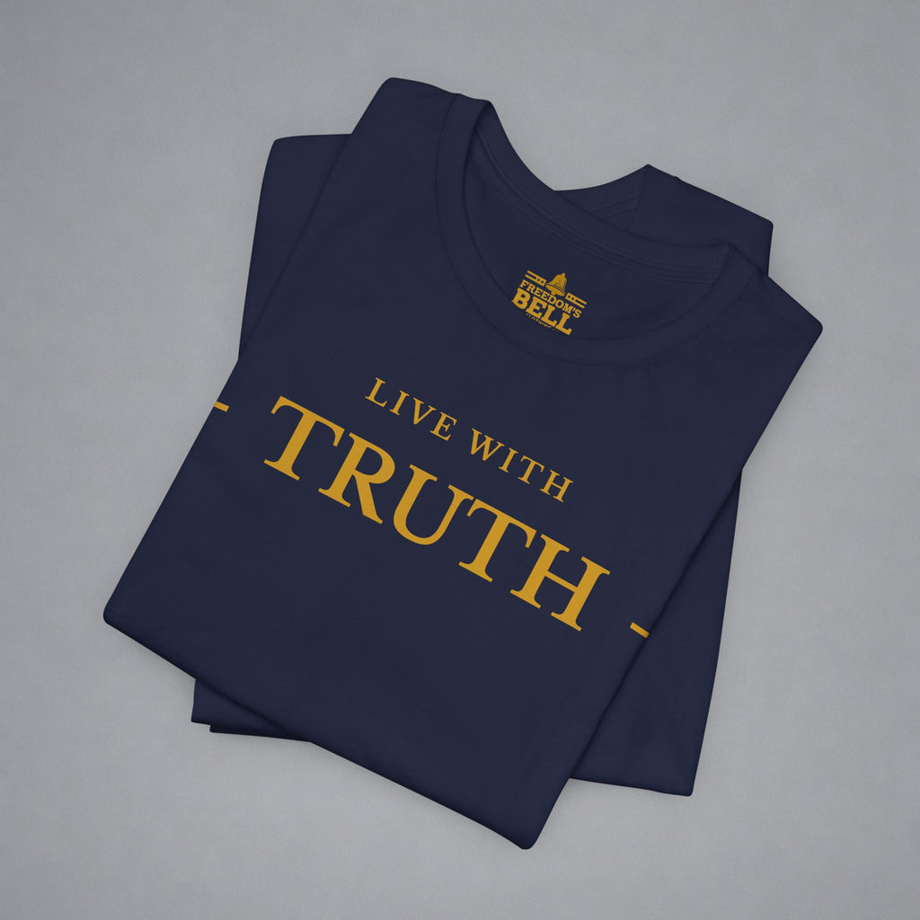A folded navy blue t-shirt with gold text reading 'LIVE WITH TRUTH' and a small 'BELLY' brand logo printed inside the collar, displayed on a neutral gray background.
