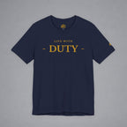 A navy blue crewneck t-shirt with 'LIVE WITH - DUTY -' printed in gold across the chest, displayed flat against a neutral gray background.