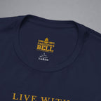 Close-up of a navy blue t-shirt collar showing a yellow printed graphic that reads 'FREEDOM'S BELL A CLOTHING' with a bell icon, on a neutral gray background.