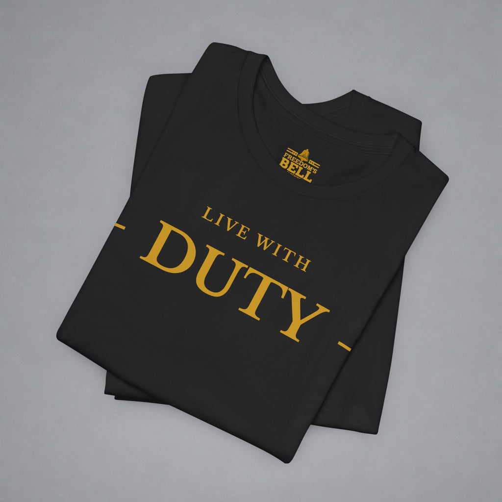 A folded black t-shirt with gold text reading 'LIVE WITH DUTY' and a gold 'BELL' logo printed inside the collar, displayed on a neutral gray background.