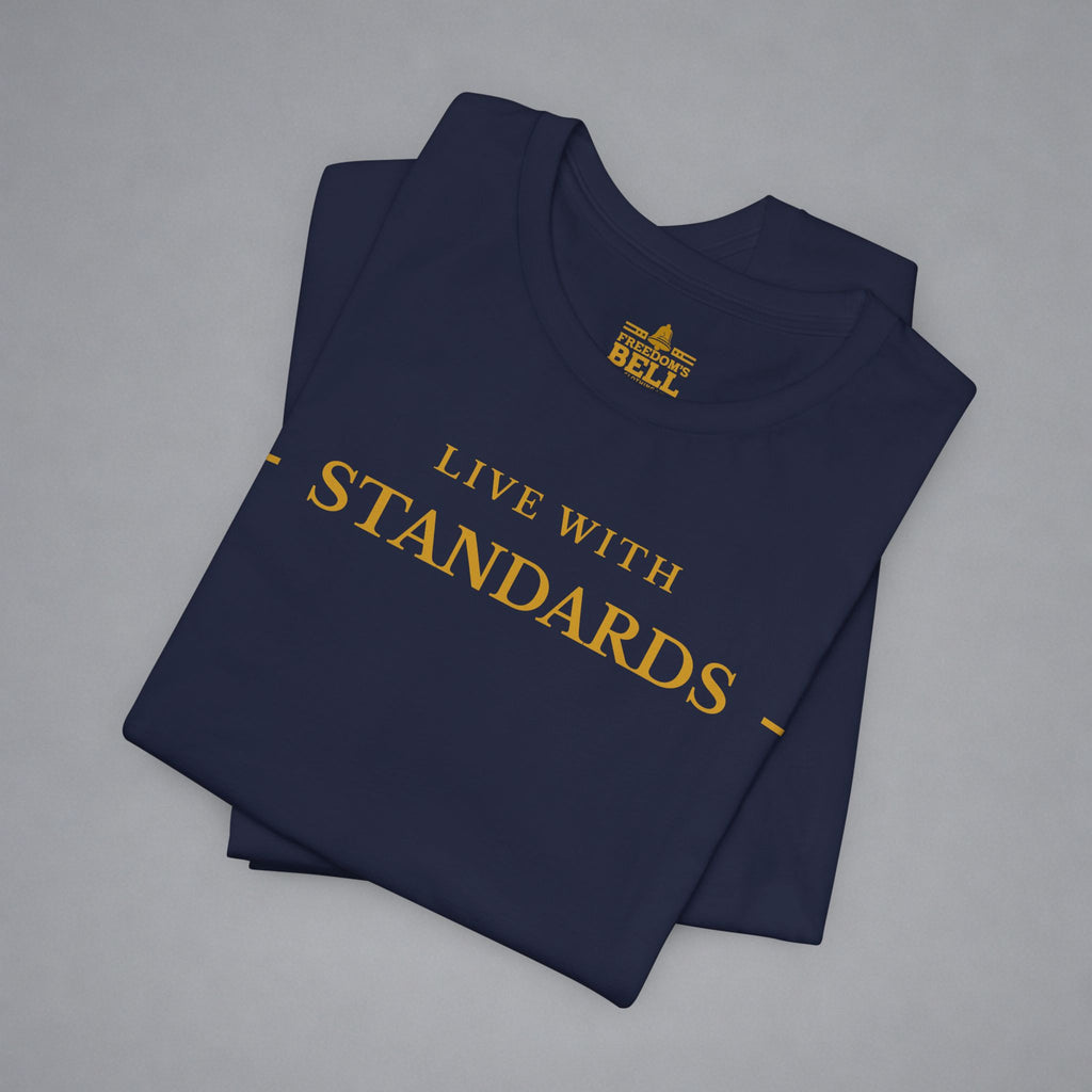 A folded navy blue t-shirt with gold text reading 'LIVE WITH INTENTION.
